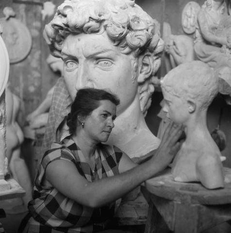 Artist Sylvia Lefkovitz examining original clay head of the bronze, “David”